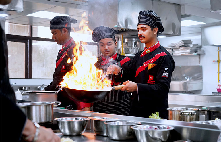 The illustration shows the students of hospitality management from chitkara university working in the kitchen.