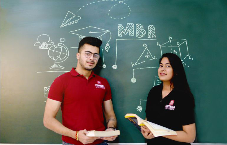 The illustration with a dark green background with many mathematical angles and symbols shows the two students of chitkara university—a boy in a red t-shirt and a girl in black. In the centre of the image, "MBA" is written with chalk.