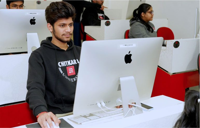 The illustration shows the students of full stack development from chitkara university working on the desktops.