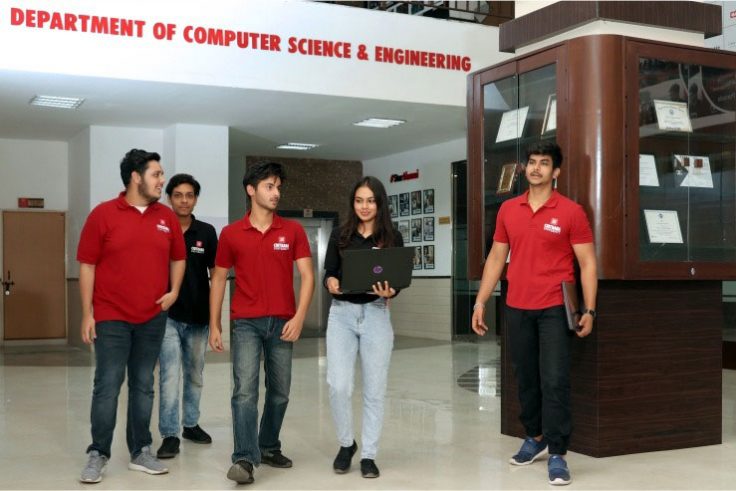 The illustration shows a student of chitkara university walking in the computer science and engineering department.