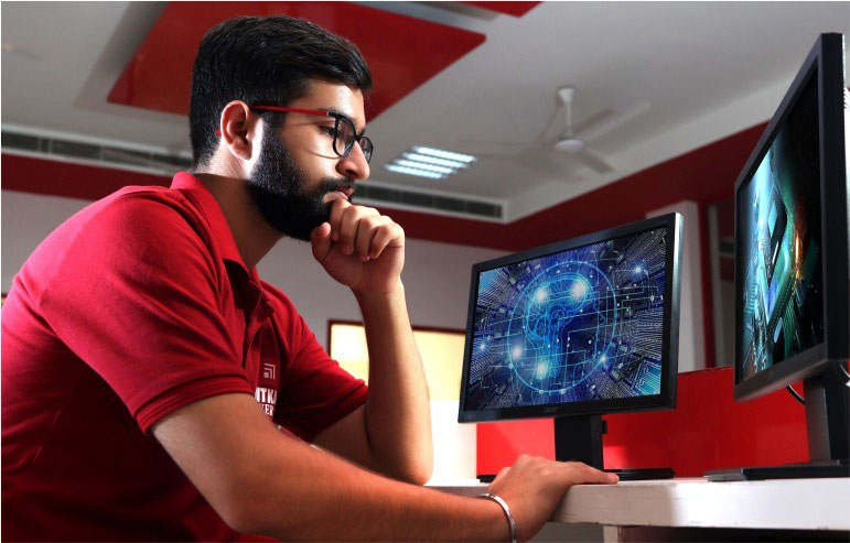 The image shows the student of chitkara university working in a computer lab.