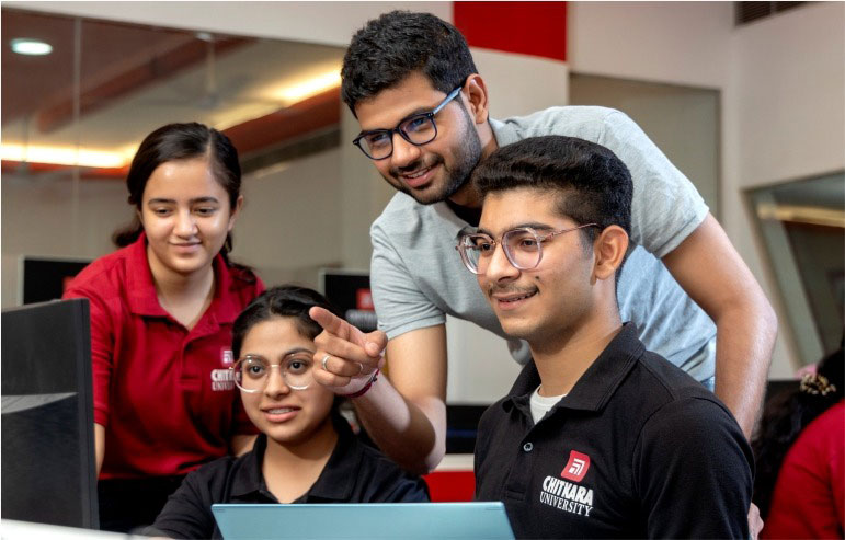 The illustration with a blurred background shows the students of chitkara university working in a computer lab.