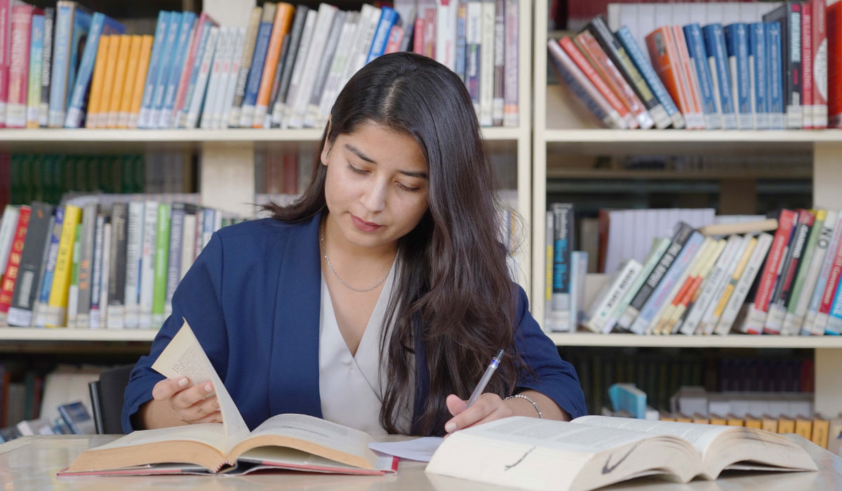 picture contains a phd student studying in the chitkara university;s library