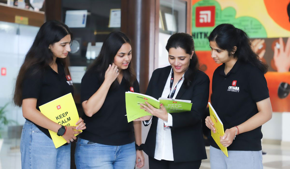 Group of B.Ed. students learning with guidance from a faculty mentor, representing how to become a teacher after graduation.