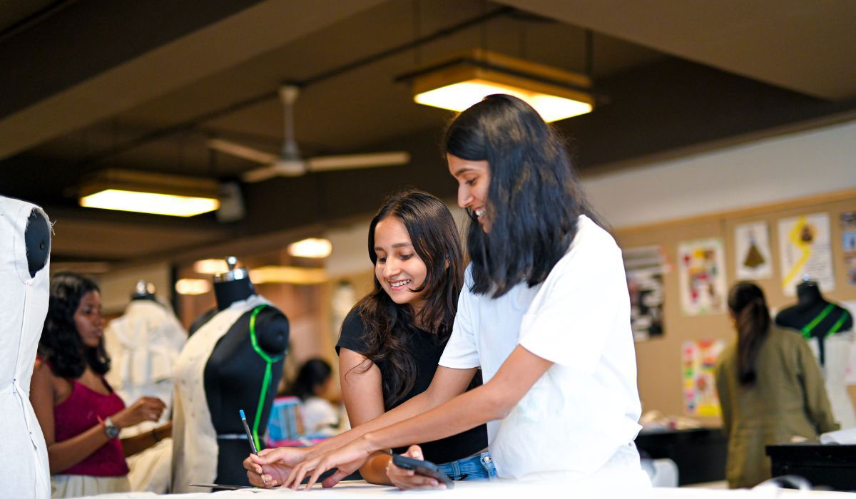 oung designers practicing garment creation as part of their Fashion Design program training.